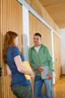 Young woman and man talking in corridor