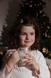 Little girl drinking a glass of milk at Christmas night Little girl drinking a glass of milk at Christmas night