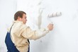 worker make renovation indoor. Paint the wall worker make renovation indoor. Paint the wall