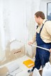 worker make renovation indoor. Painting wall worker make renovation indoor. Painting wall