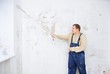 Man painting wall with roller Man painting wall with roller