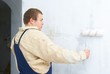 worker painting wall with roller worker painting wall with roller