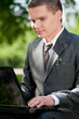 business man work on notebook at park. Student