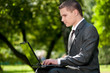 business man work on notebook at park. Student