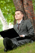 business man work on notebook at park. Student