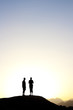 2 people standing on top of a mountain