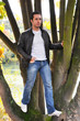 Young man standing on a tree