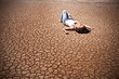 Young woman lying on a deserted land