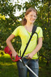 Girl works with  trimmer