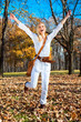 Foto: Happy woman in the autumn colored park . Happy woman in the autumn colored park .
