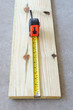 Wood plank and tape measure