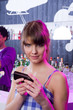 Photo: Smiling woman using cellular phone at bar Smiling woman using cellular phone at bar