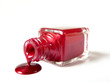 Red nail polish is flowing from the bottle isolated on white Red nail polish is flowing from the bottle isolated on white