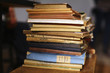 Pile of old literature books stacked on the shelf
