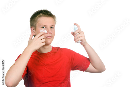 Photo: The boy, the teenager with a cream for a problem youthful skin The boy, the teenager with a cream for a problem youthful skin