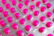 pack of pink medicine pills background
