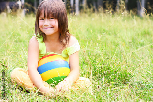 Photo: The child sit on a grass The child sit on a grass