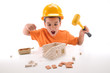 Frustrated little boy breaking model house with hammer.