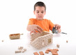 Little boy measuring model house isolated on white.