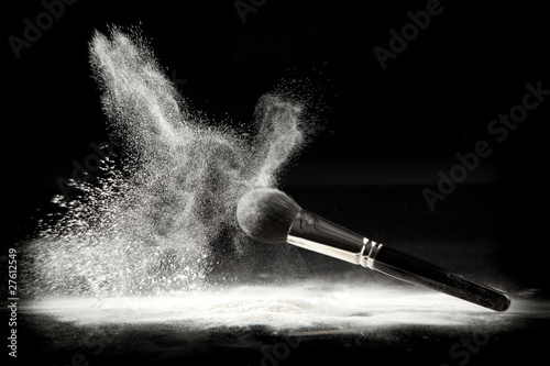 Photo: a composition with a powder brush and white loose powder a composition with a powder brush and white loose powder