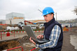 Foto: Engineer on construction site with laptop computer Engineer on construction site with laptop computer