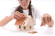 Cool girl building house isolated on white.