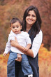 Photo: Autumn portrait of mom holding toddler child Autumn portrait of mom holding toddler child