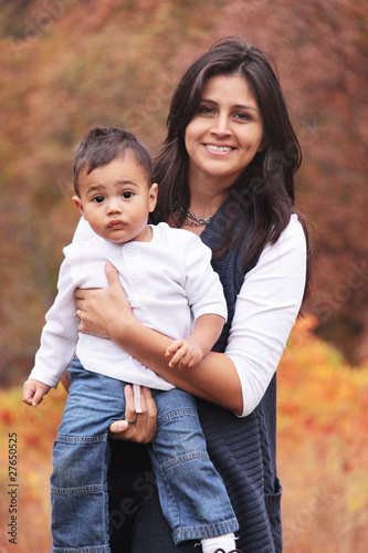 Photo: Autumn portrait of mom holding toddler child Autumn portrait of mom holding toddler child