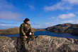 Man sits on a mountain top. Ridge Musta Tunturi.