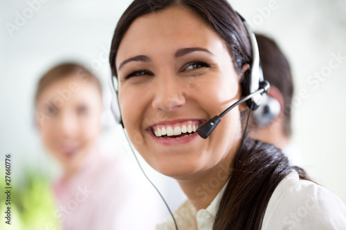 Foto : Happy woman in a call center Happy woman in a call center