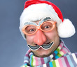 man in a ridiculous Santa Claus mask in the warm scarf