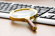 Computer security concept with keyboard and magnifying glass