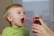 Photo: 2 years old baby boy and medicine, cough syrup 2 years old baby boy and medicine, cough syrup