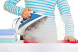 Young lady ironing her clothes