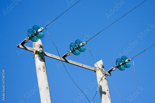Photo: Electricity Poles with Wires and Green Glass Insulators against Electricity Poles with Wires and Green Glass Insulators against