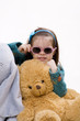 Child sitting on flor with glas and toys