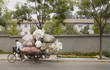 Chinese man on overloaded bike