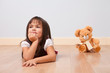 Cute girl on a wooden floor