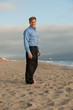Good looking male business man on the beach in casual attire