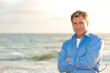 Photo: attractive man on the beach in casual business attire attractive man on the beach in casual business attire