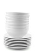 a stack of white dishes and bowls isolated on white