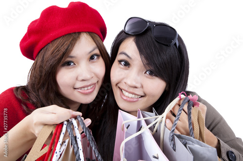 Photo: Two Beauty shopping sisters isolated Two Beauty shopping sisters isolated
