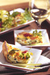 Casserola on plate with white wine in the background.