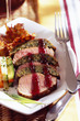 veal filets with bread, vegtables and a fork