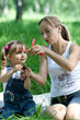 Mother and daughter in jeans with toy outdoor