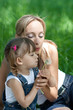 Mother and daughter in jeans with dandelion outdoor