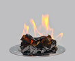 Burning paper on a metal tray.