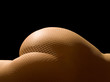 Female body in openwork stockings isolated on black background.