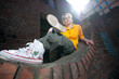 Teenage hip-hop girl on red brick wall