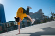 Teenage hip-hop girl dancing over city landscape
